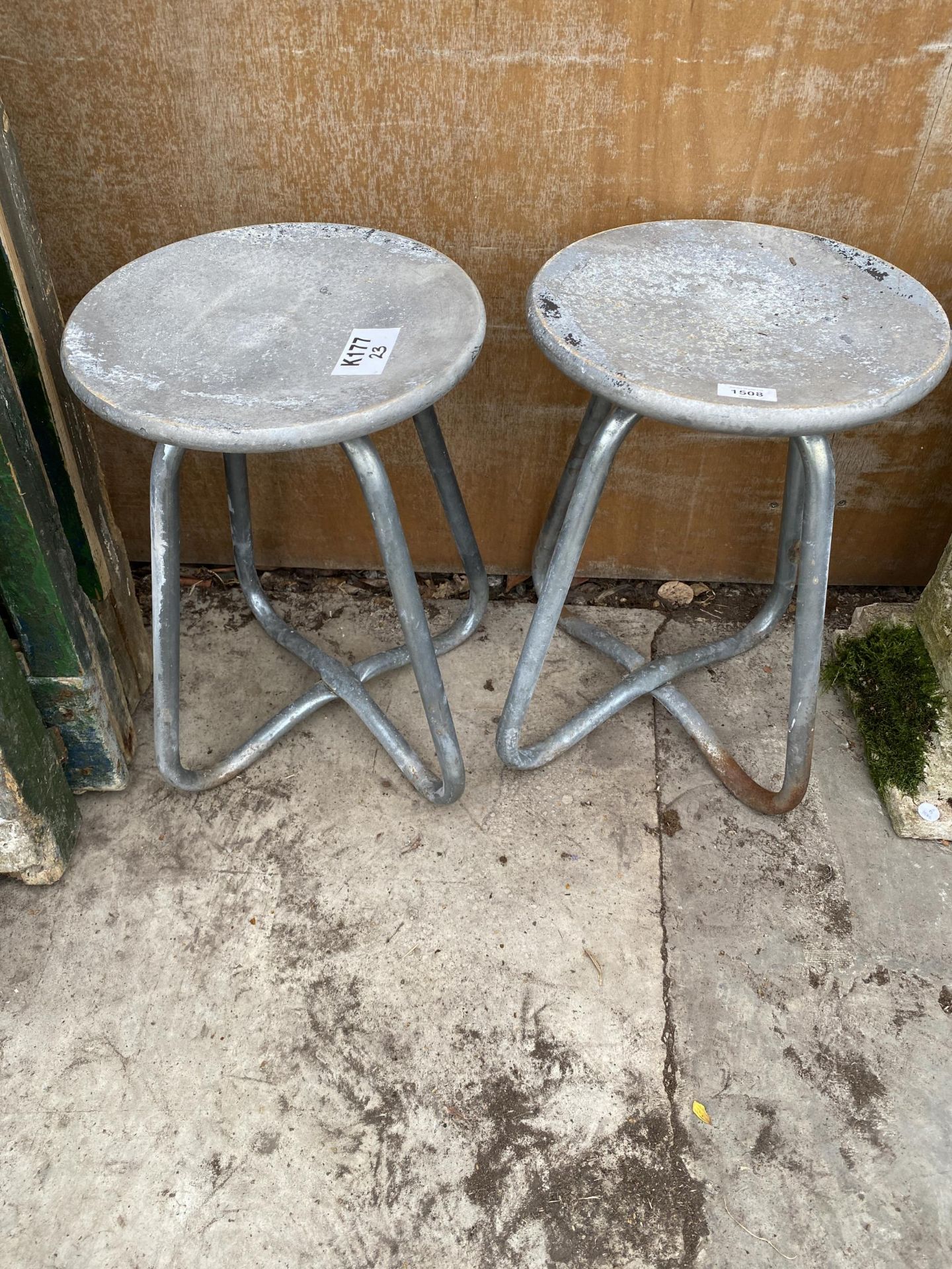 A PAIR OF ALLOY STOOLS WITH STEEL LEGS