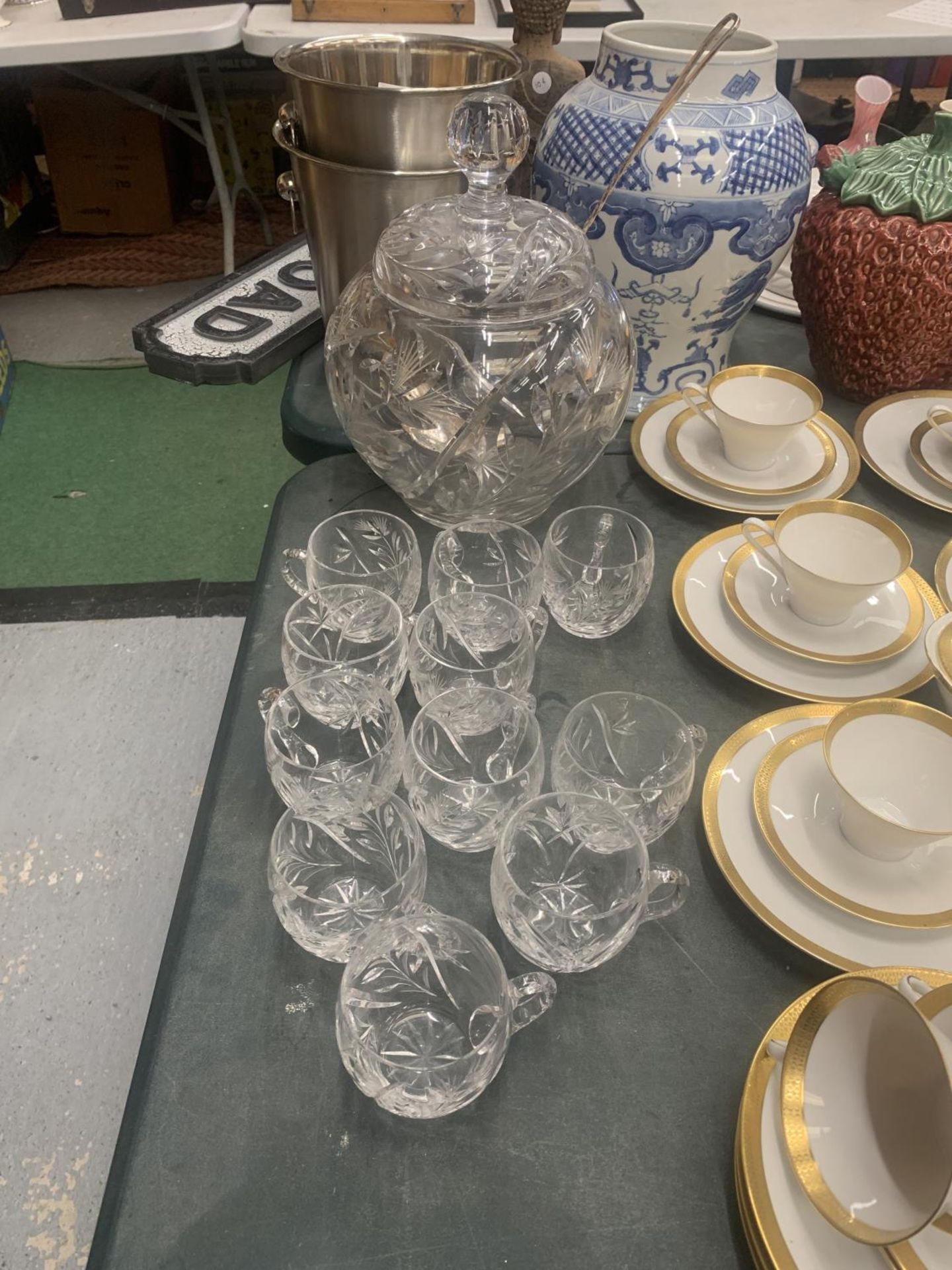 A HEAVY CUT GLASS PUNCH BOWL WITH LID, PUNCH GLASSES AND A STAMPED WMF SILVER PLATED LADEL WITH