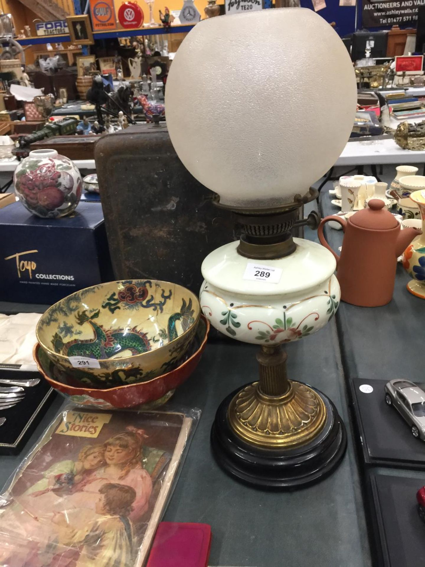 AN OIL LAMP ON WOODEN BASE