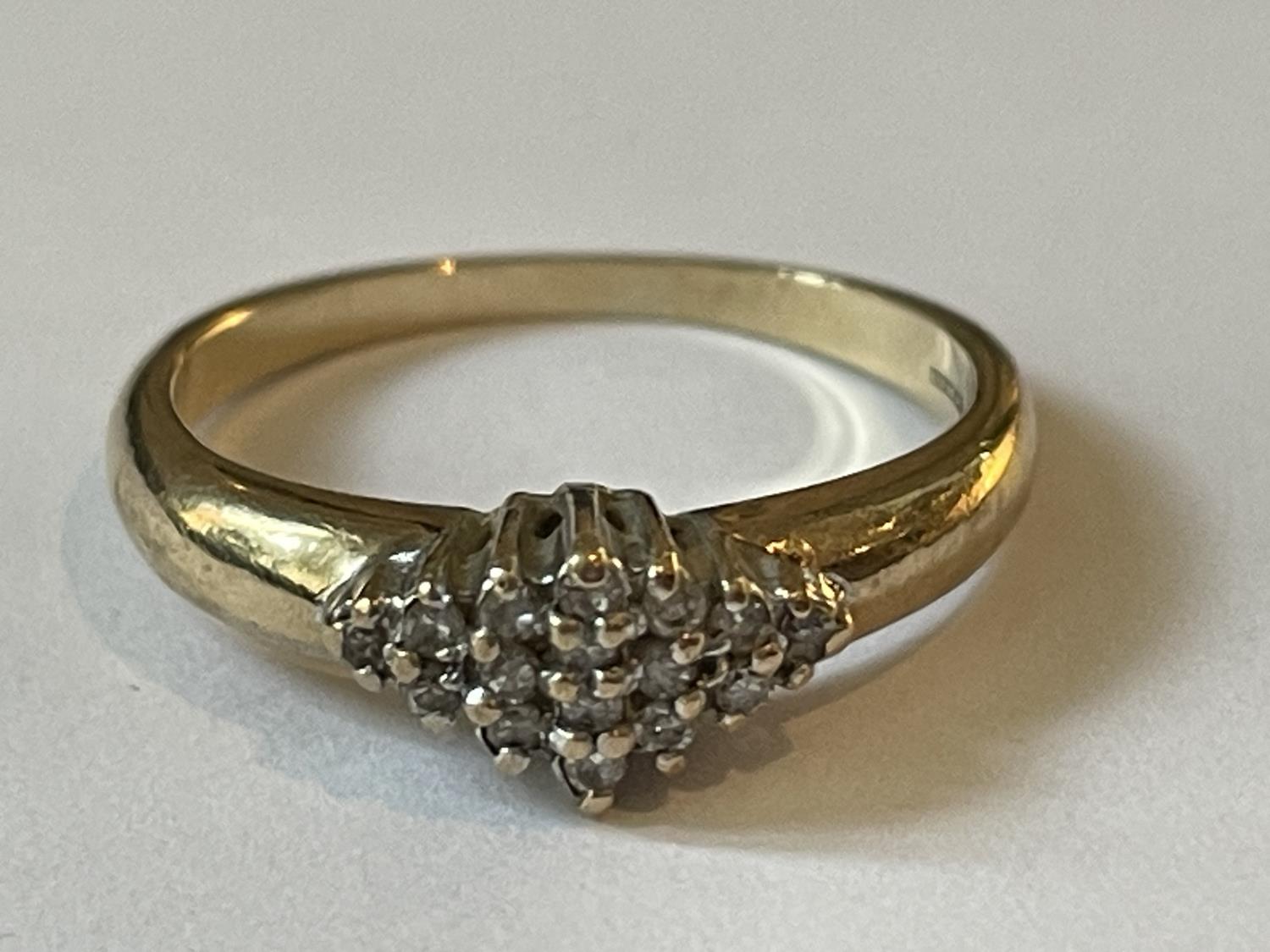 A 9 CARAT GOLD RING WITH DIAMONDS SET IN A DIAMOND SHAPE