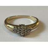 A 9 CARAT GOLD RING WITH DIAMONDS SET IN A DIAMOND SHAPE