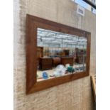 A LARGE PINE FRAMED WALL MIRROR