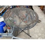 A METAL FODING BISTRO TABLE