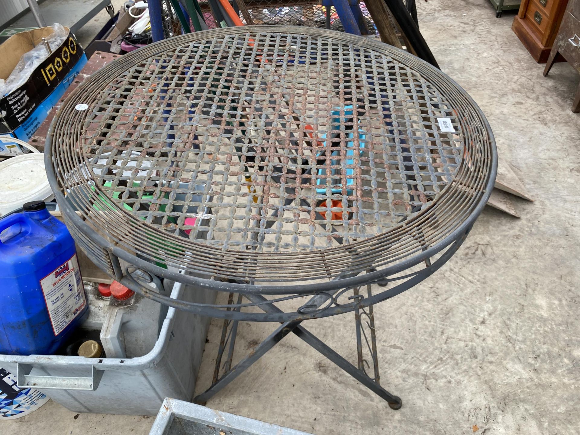 A METAL FODING BISTRO TABLE