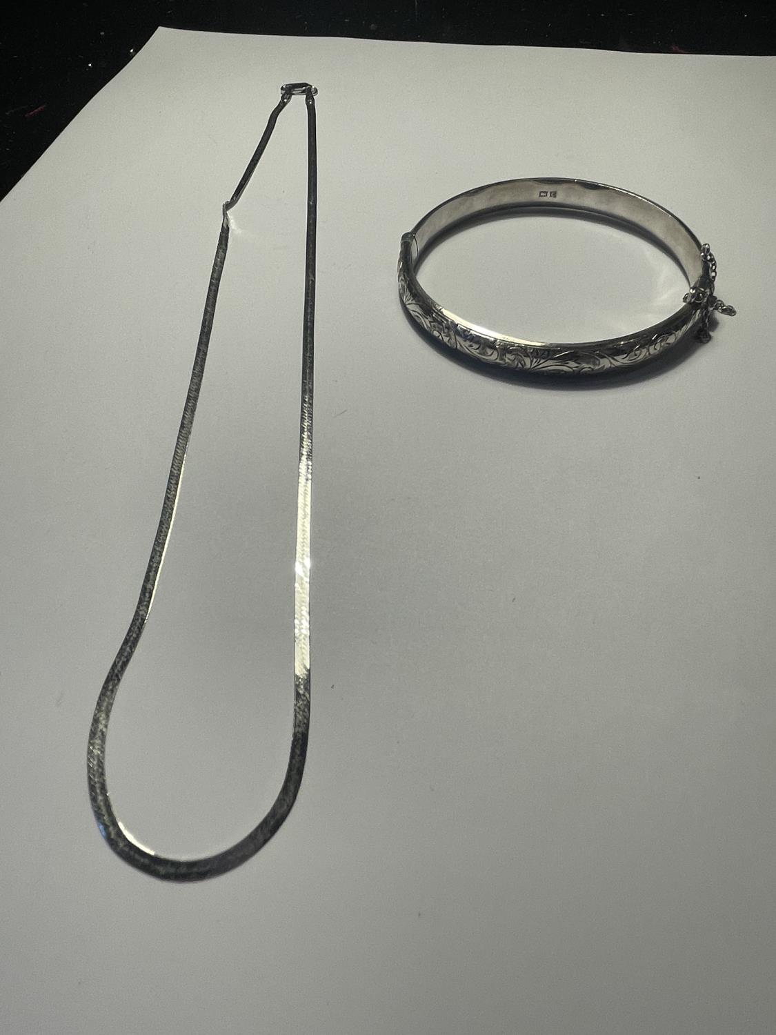 A SILVER BANGLE AND NECKLACE