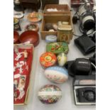 A QUANTITY OF COLLECTABLE TINS, EGGS, A FIRST AID BOX, ETC