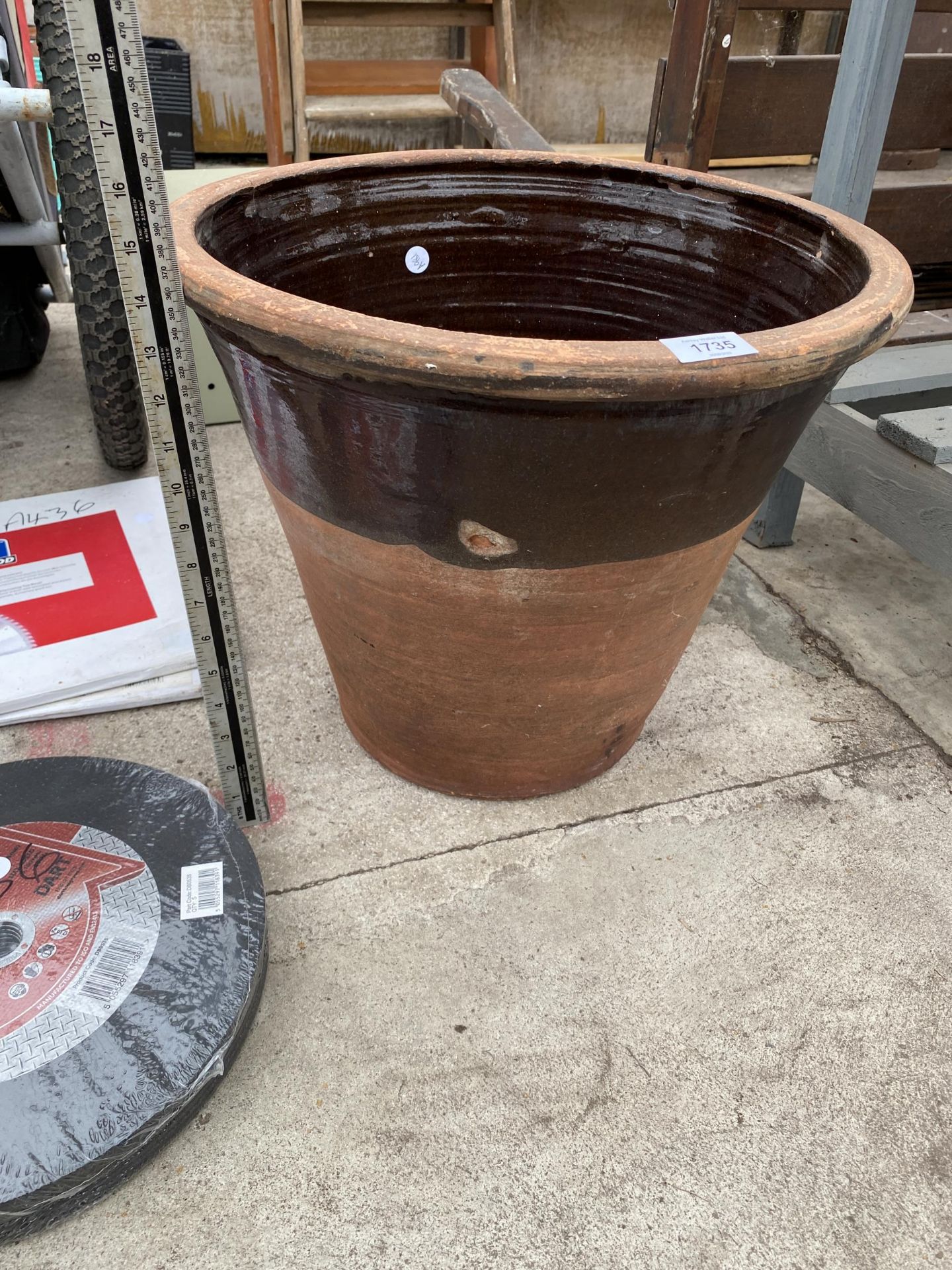 A LARGE BROWN GLAZED TERRACOTTA PLANTER