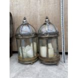 A PAIR OF DOMED GLASS AND METAL CANDLE LANTERNS