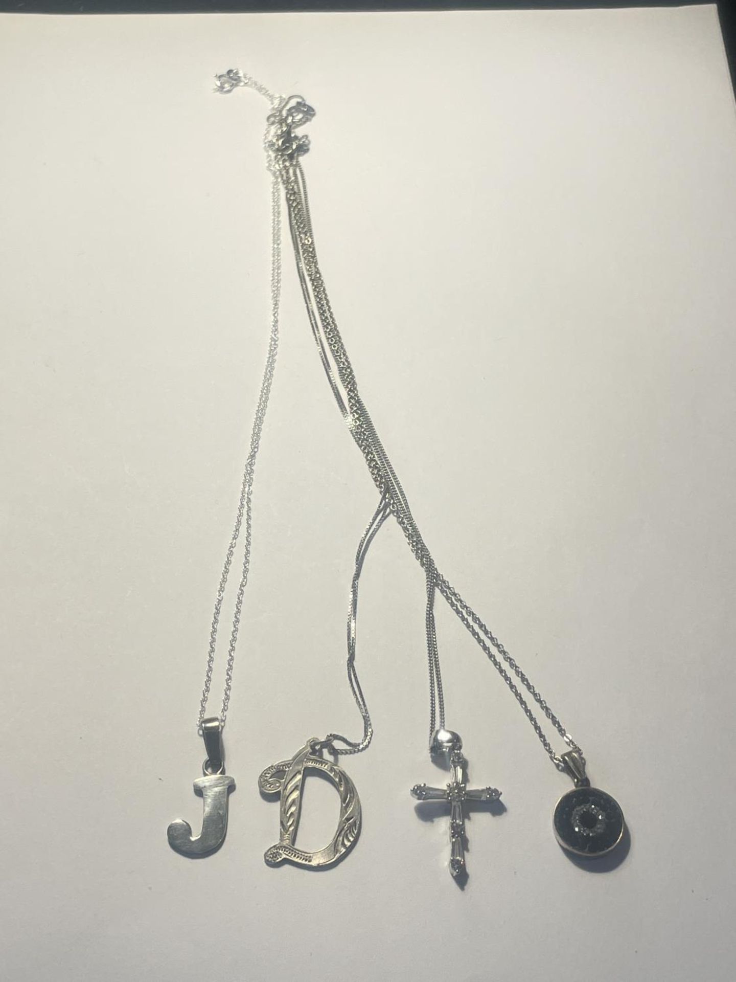 FOUR SILVER NECKLACES WITH PENDANTS