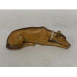 A POSSIBLY DOULTON UNMARKED LYING DOWN DOG ANIMAL FIGURE