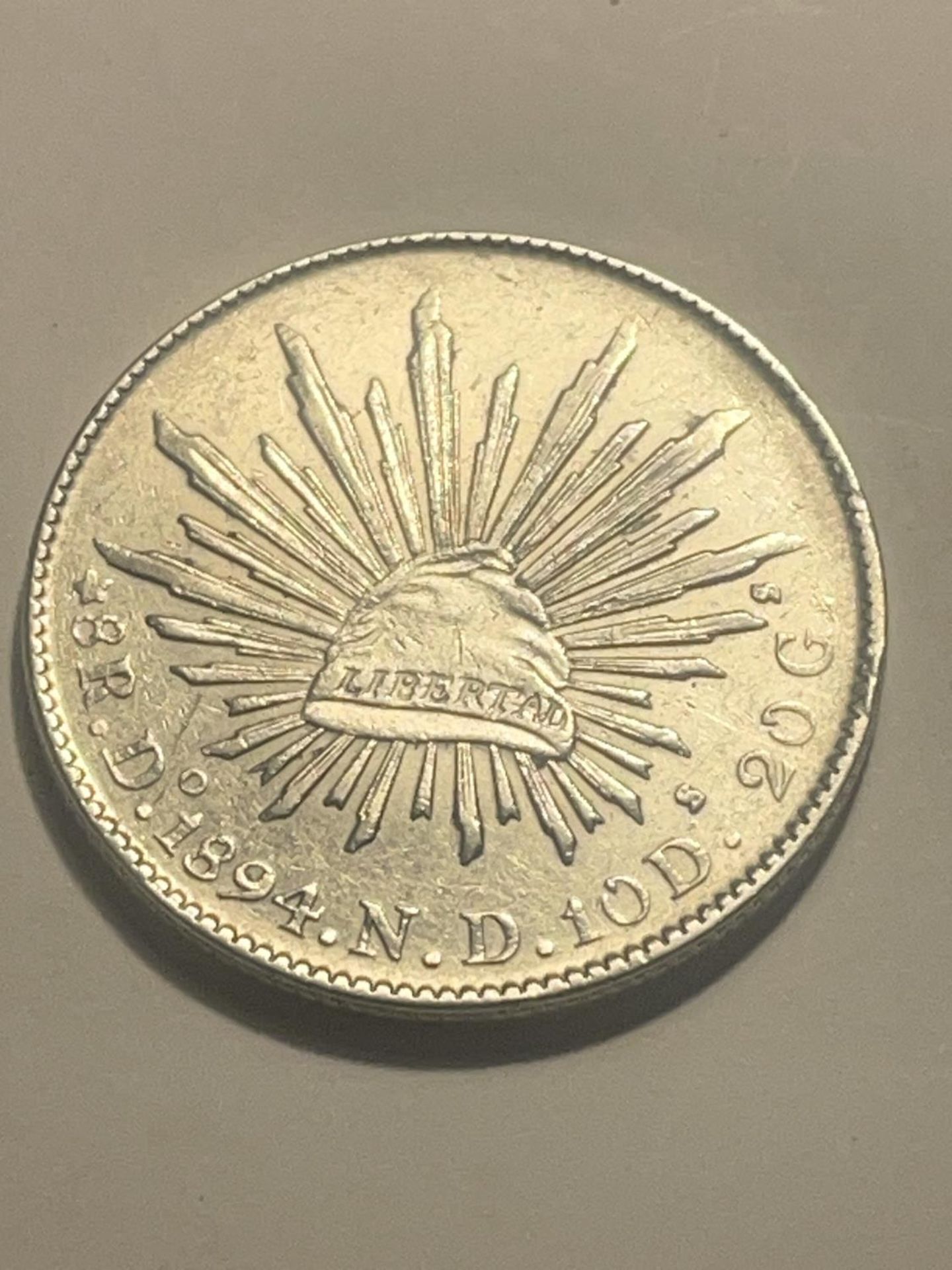 A MEXICAN 1894 SILVER COIN