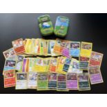 TWO TINS OF ASSORTED POKEMON CARDS, HOLOS ETC