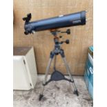 A CALESTRON ASTROMASTER 76 TELESCOPE WITH TRIPOD STAND