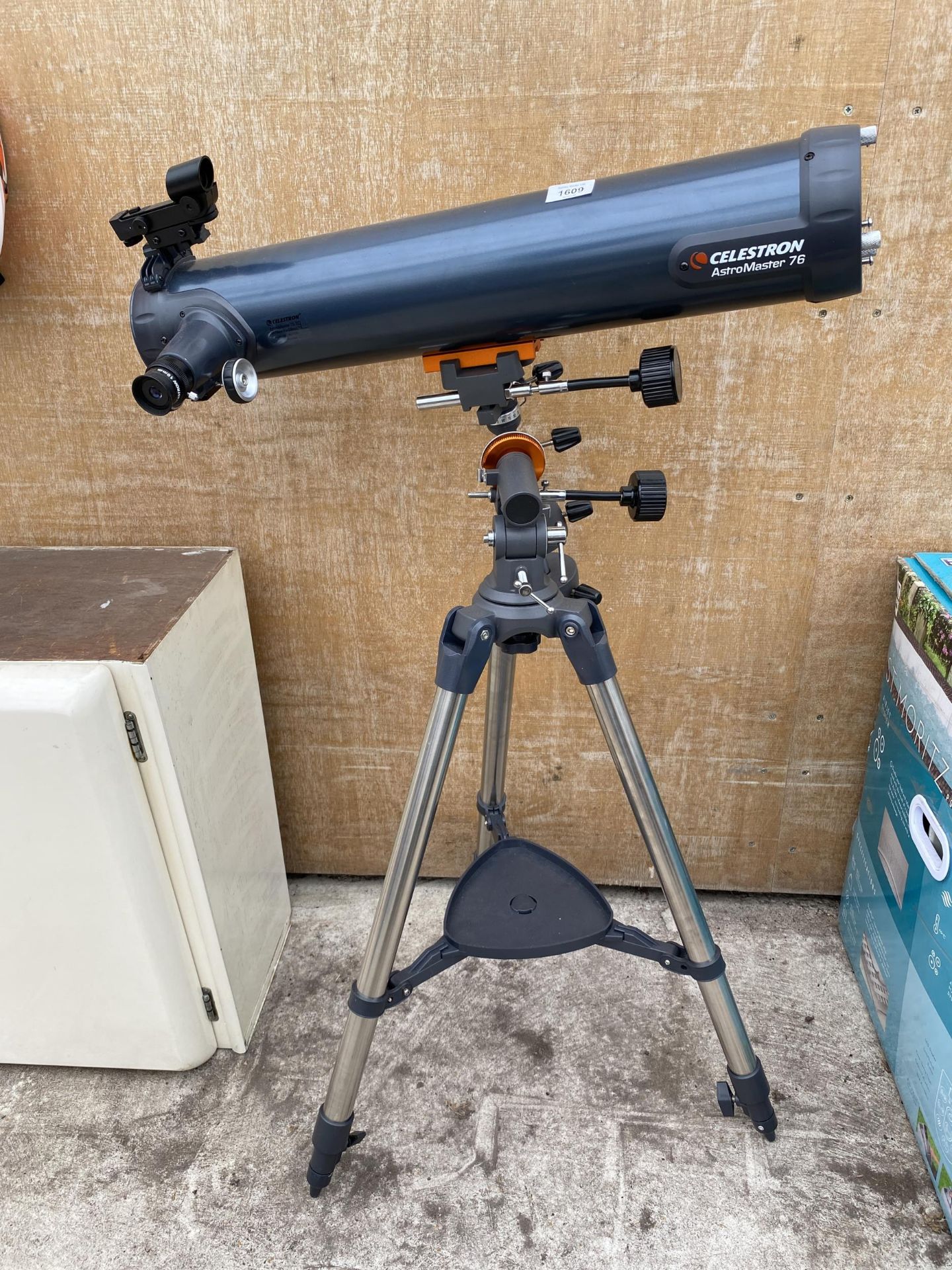 A CALESTRON ASTROMASTER 76 TELESCOPE WITH TRIPOD STAND