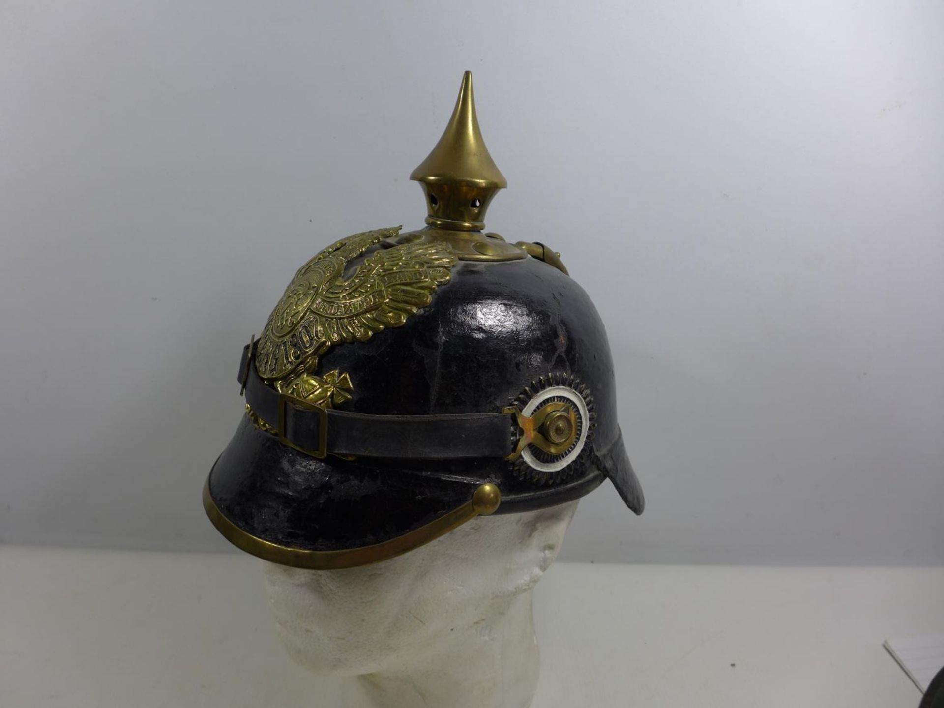 A REPLICA IMPERIAL GERMAN PICKELHAUBE LEATHER COVERED HELMET WITH LEATHER LINING