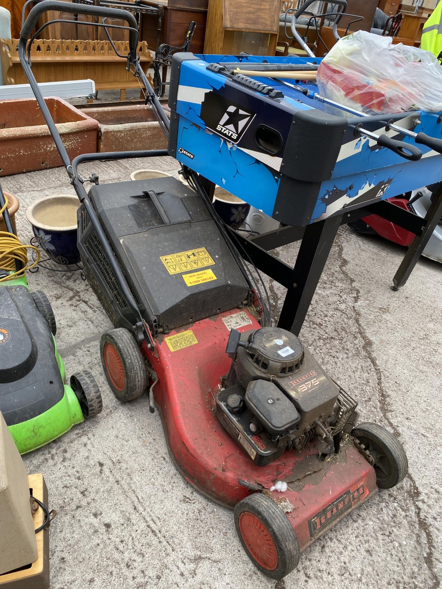 A SELF PROPELLED CHAMPION 375 PETROL LAWN MOWER WITH GRASS BOX (LARGE HOLE TO THE DECK)
