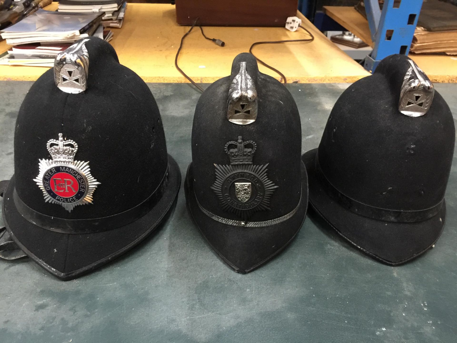 A GROUP OF THREE POLICEMAN HATS, GREATER MANCHESTER ETC