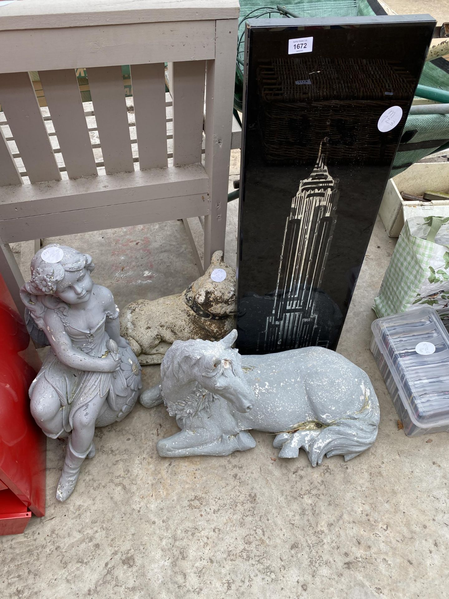 AN ILLUMINATED WALL HANGING AND THREE VARIOUS GARDEN FIGURES