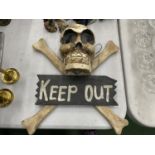A WOODEN SKULL AND CROSSBONES 'KEEP SIGN' SIGN