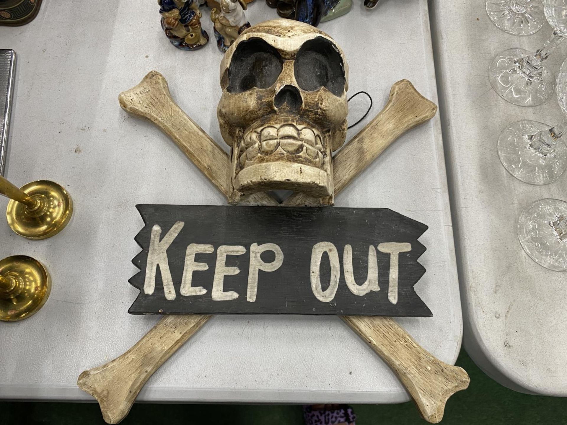 A WOODEN SKULL AND CROSSBONES 'KEEP SIGN' SIGN