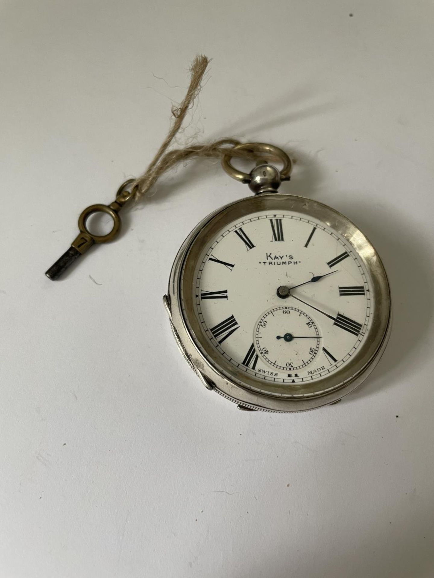A SILVER POCKET WATCH WITH KEY SEEN WORKING BUT NO WARRANTY
