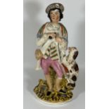 AN ANTIQUE STAFFORDSHIRE FIGURE OF A GENTLEMAN WITH SPANIEL, HEIGHT 38CM