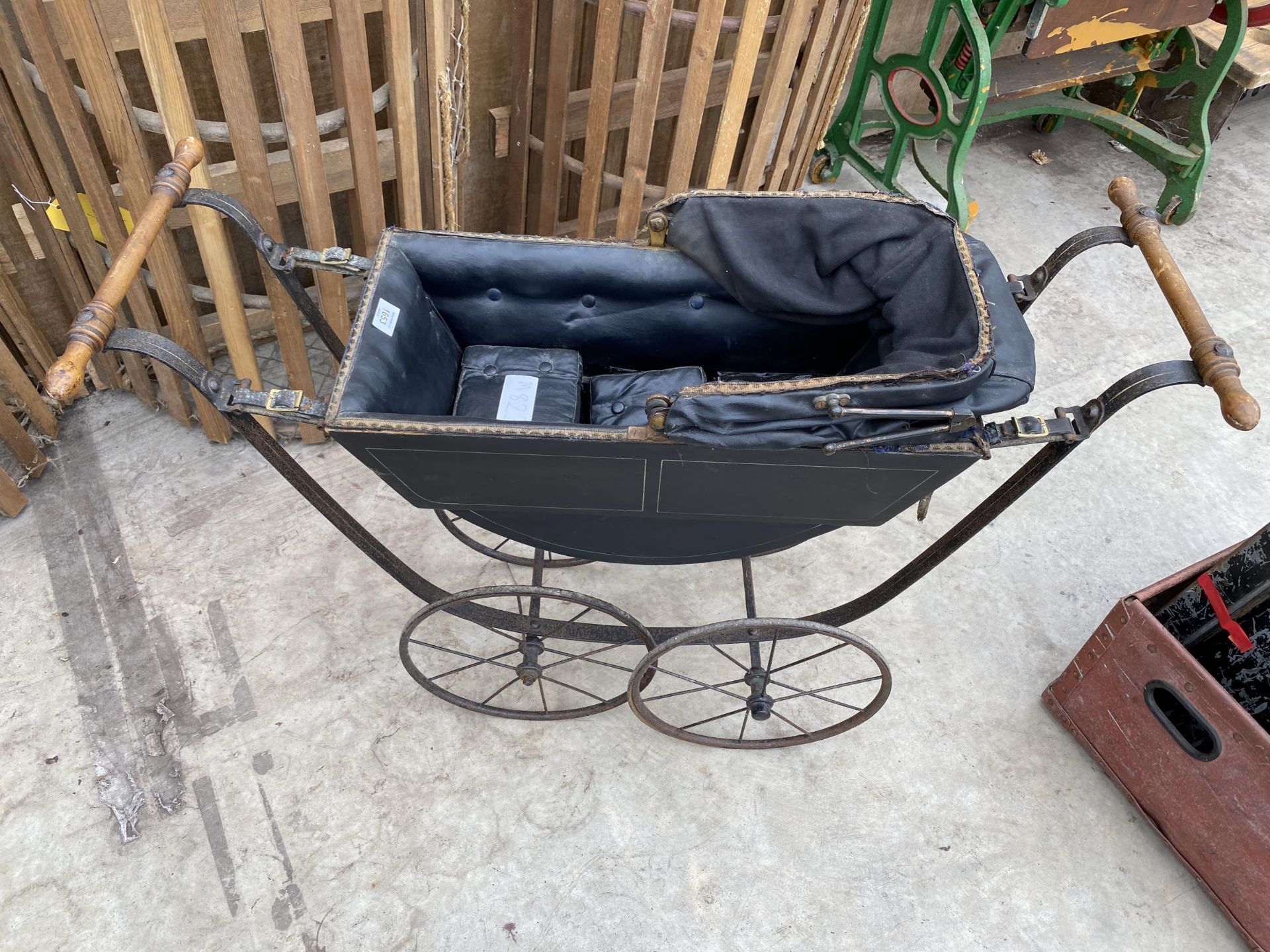 A VINTAGE FOUR WHEELED DOLLS PRAM