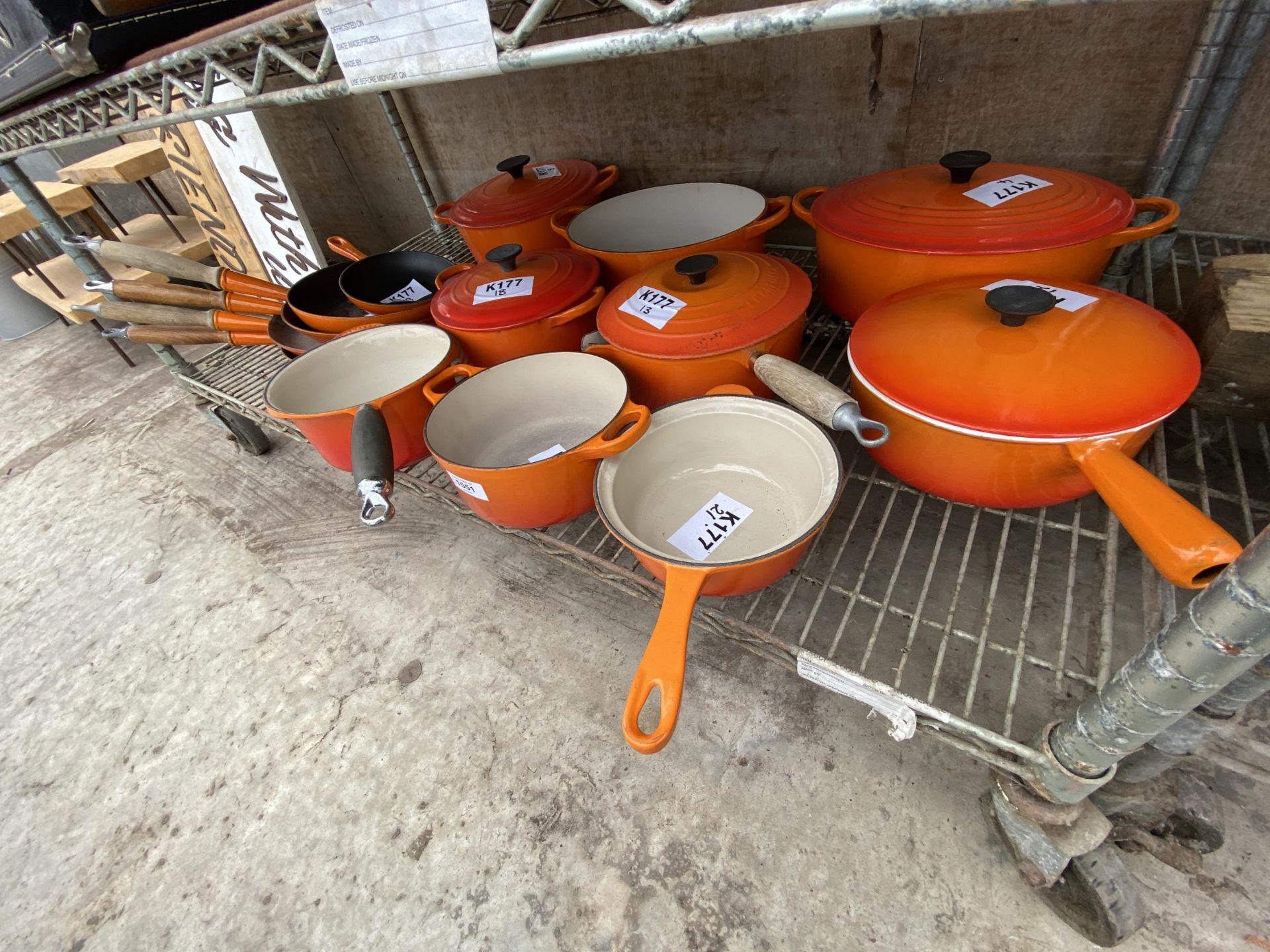 A LARGE COLLECTION OF ORANGE LE CREUSET PANS TO INCLUDE CASAROLE DISHES, VARIOUS SIZED SAUCEPANS AND