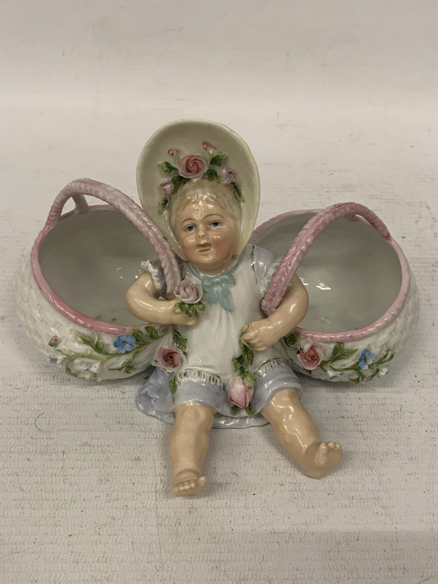 A CONTINENTAL DRESDEN STYLE PORCELAIN VASE WITH A CHILD HOLDING TWO BASKETS, BLUE CROSS SWORDS