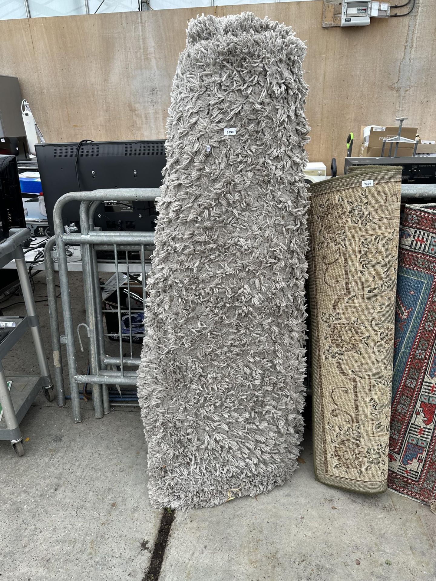 A LARGE PLUSH GREY SHAGGY RUG