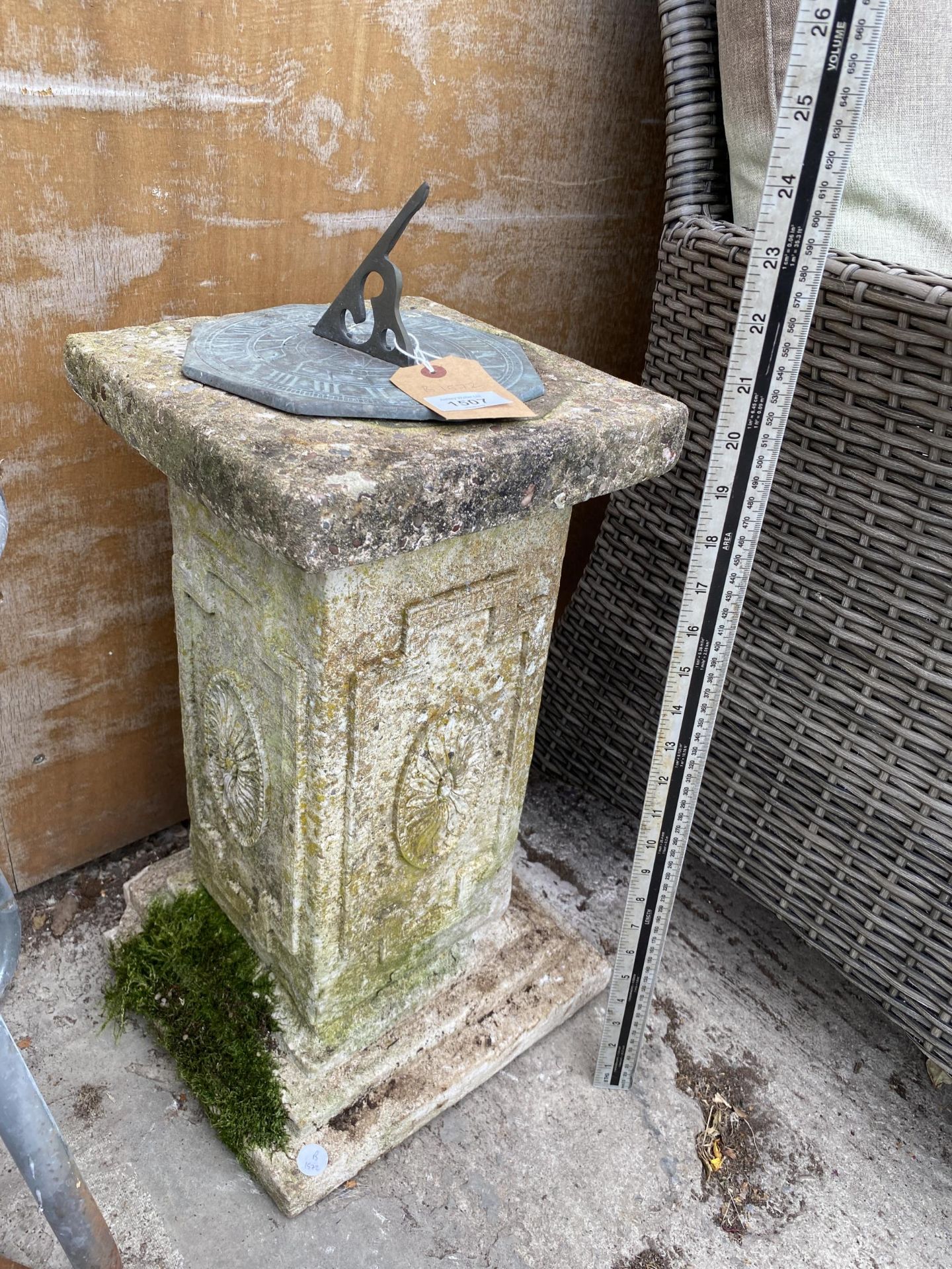 A RECONSTITUED STONE PEDESTAL BASE WITH BRASS SUN DIAL TOP