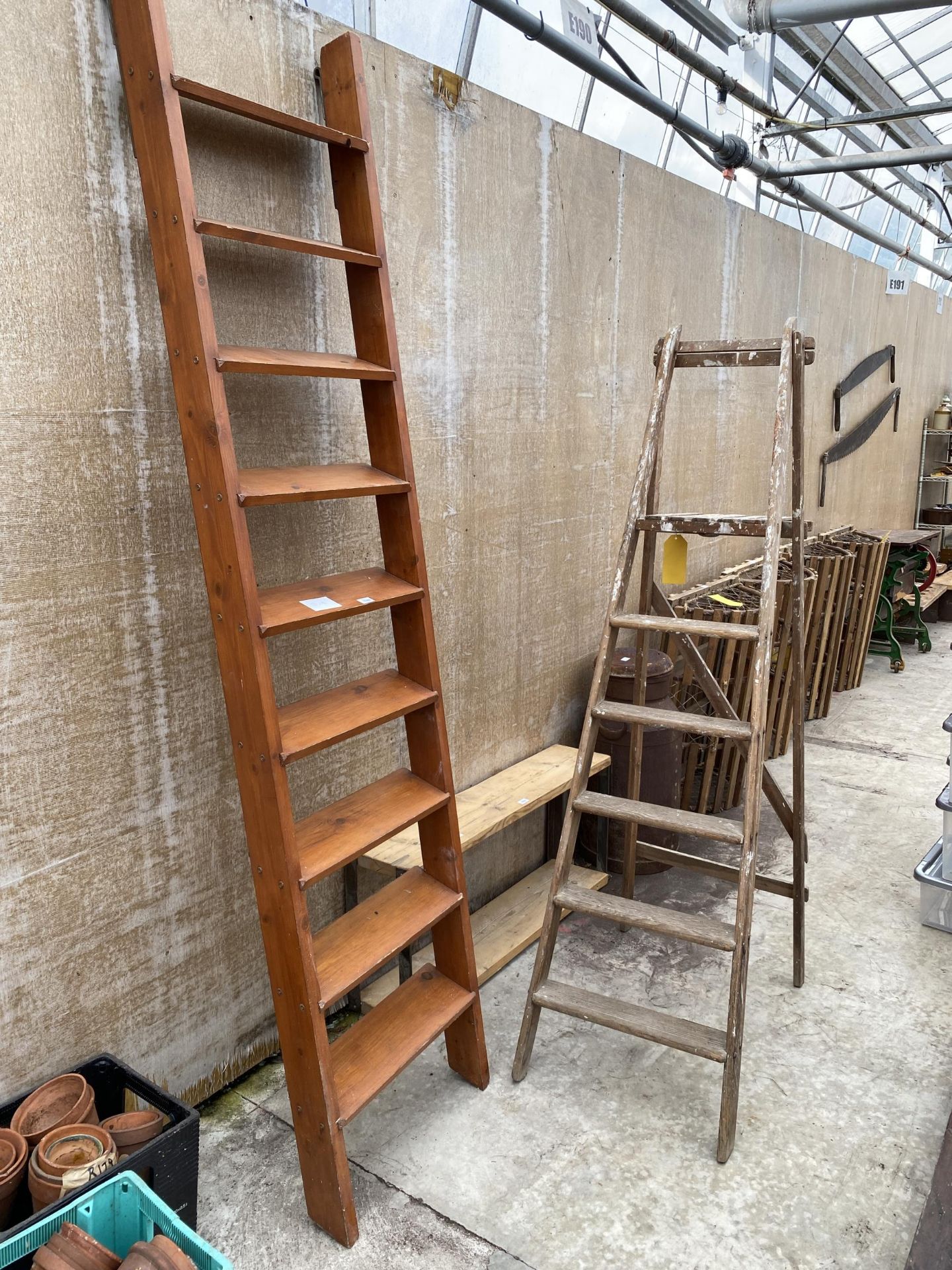 A WOODEN NINE RUNG LADDER AND A VINTAGE FIVE RUNG WOODEN STEP LADDER