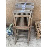 A SET OF FOUR TEAK FOLDING GARDEN CHAIRS