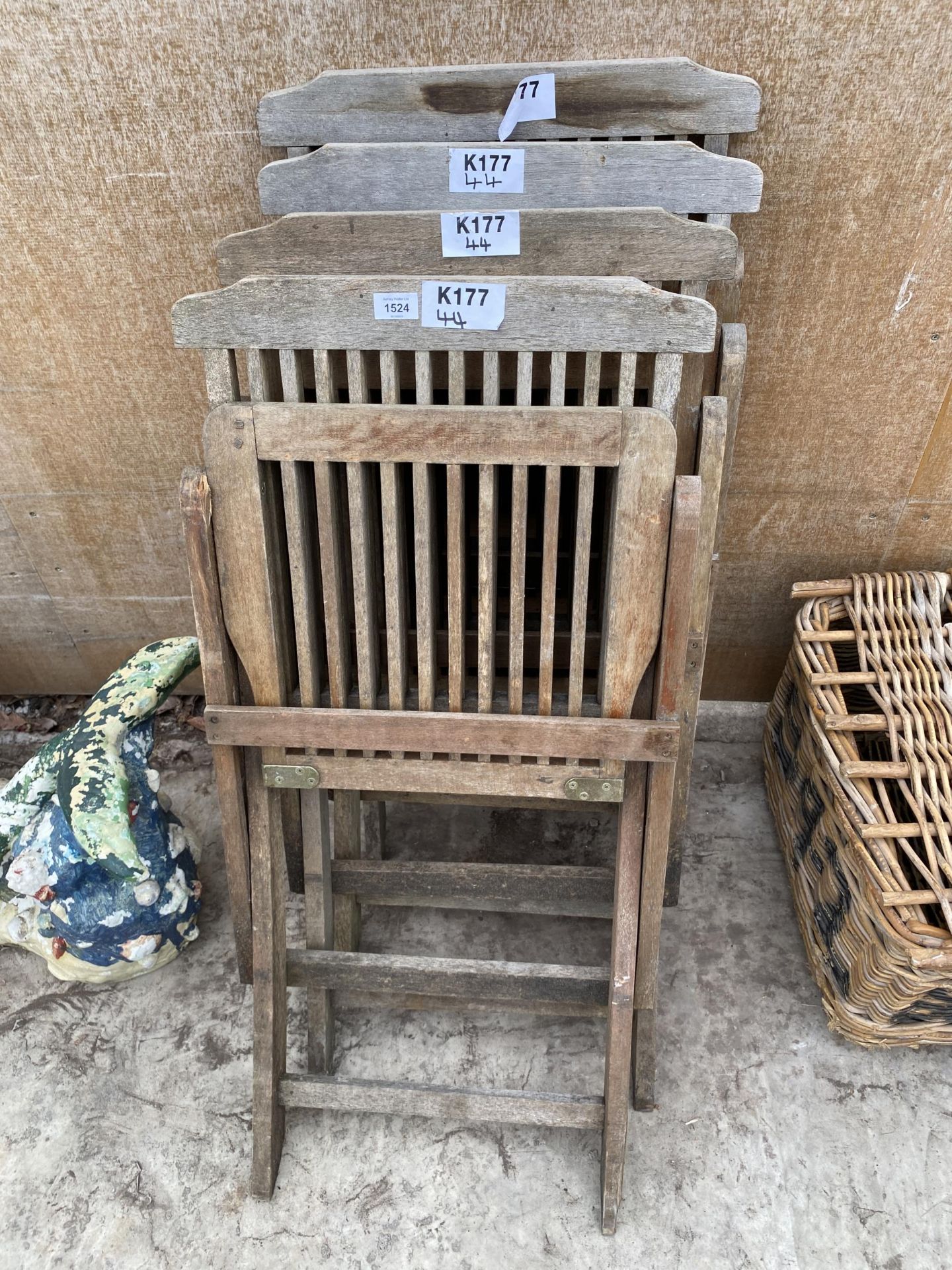 A SET OF FOUR TEAK FOLDING GARDEN CHAIRS