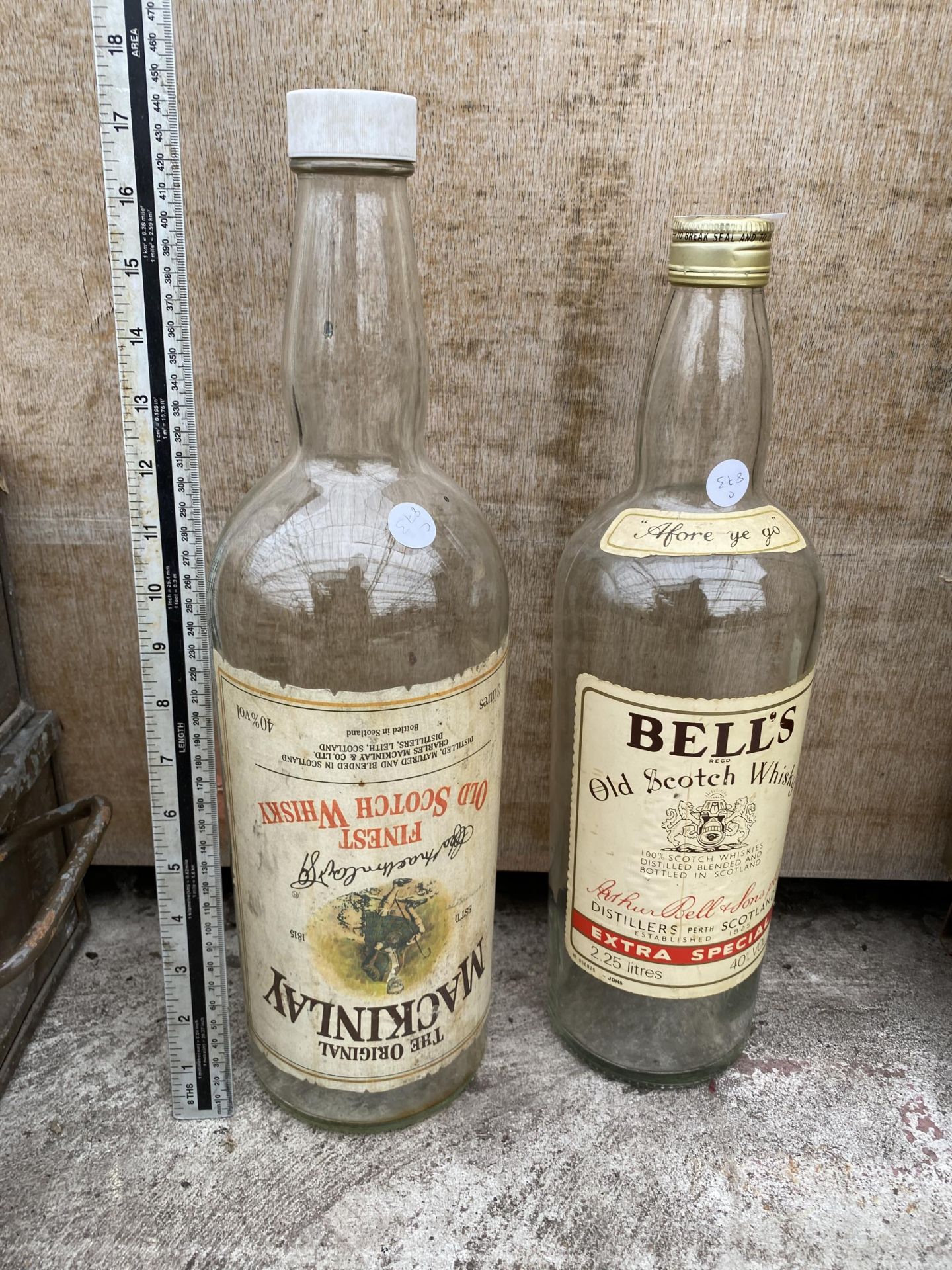 A LARGE BELLS SCOTCH WHISKEY BOTTLE AND A FURTHER LARGE MACKINLAY BOTTLE