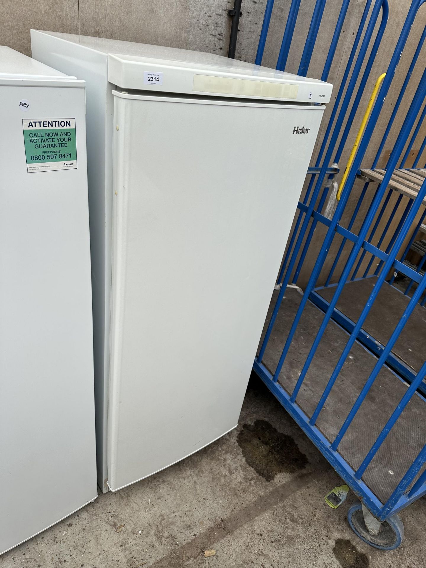 A WHITE HAIER UPRIGHT FRIDGE