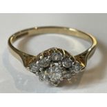 A 9 CARAT GOLD RING WITH NINE CUBIC ZIRCONIAS IN A DIAMOND PATTERN SIZE P