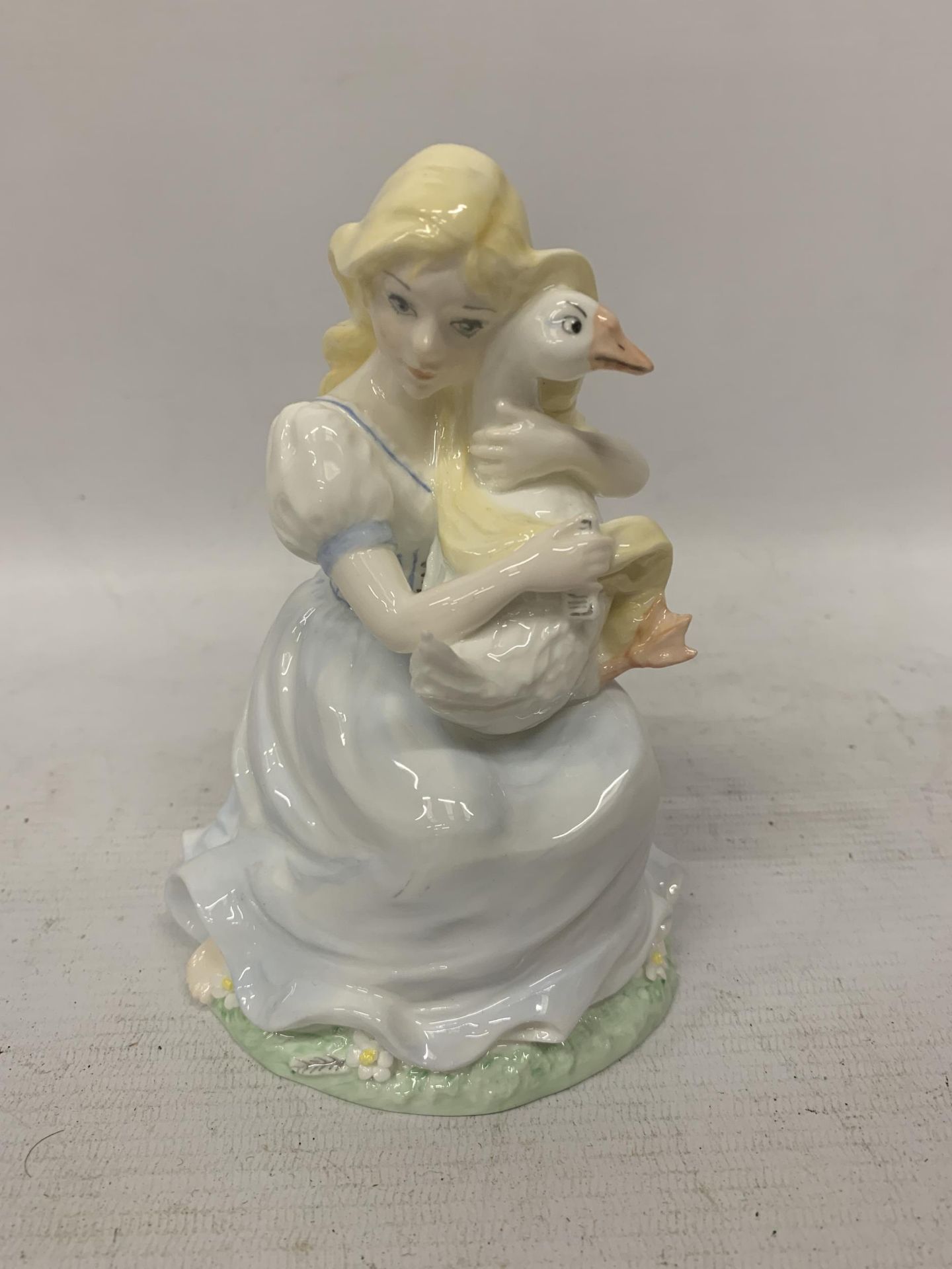 A COALPORT LIMITED EDITION 'THE GOOSE GIRL' FIGURE