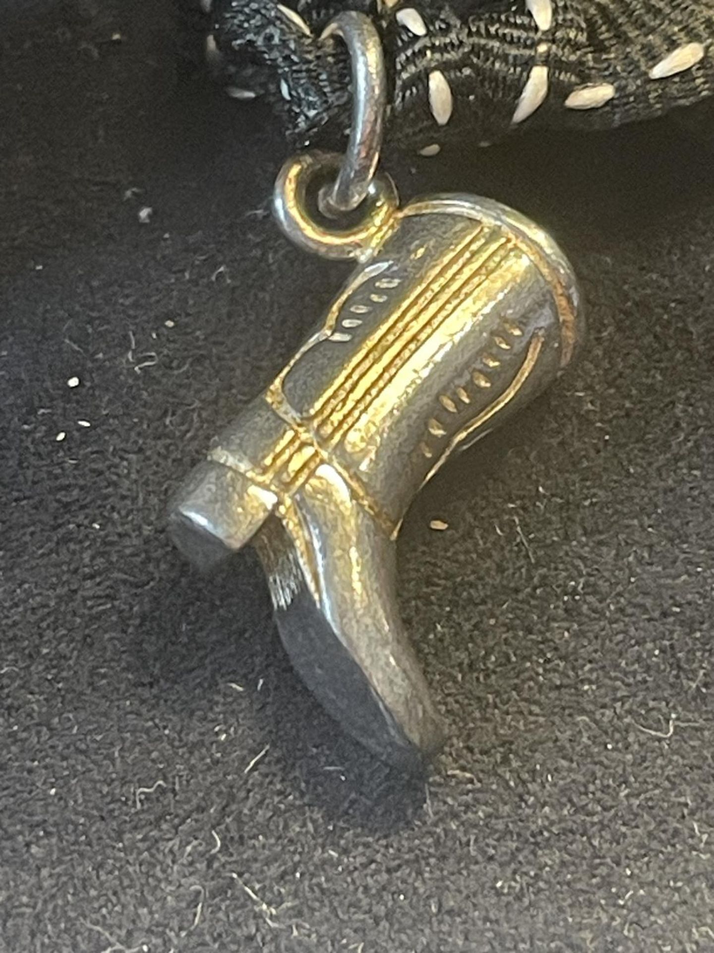 A COWBOY BOOT CHARM IN A PRESENTATION BOX