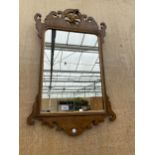 A DECORATIVE WALNUT FRAMED WALL MIRROR