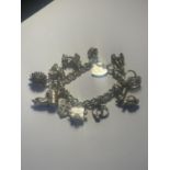 A SILVER CHARM BRACELET WITH ELEVEN CHARMS AND A HEART LOCK