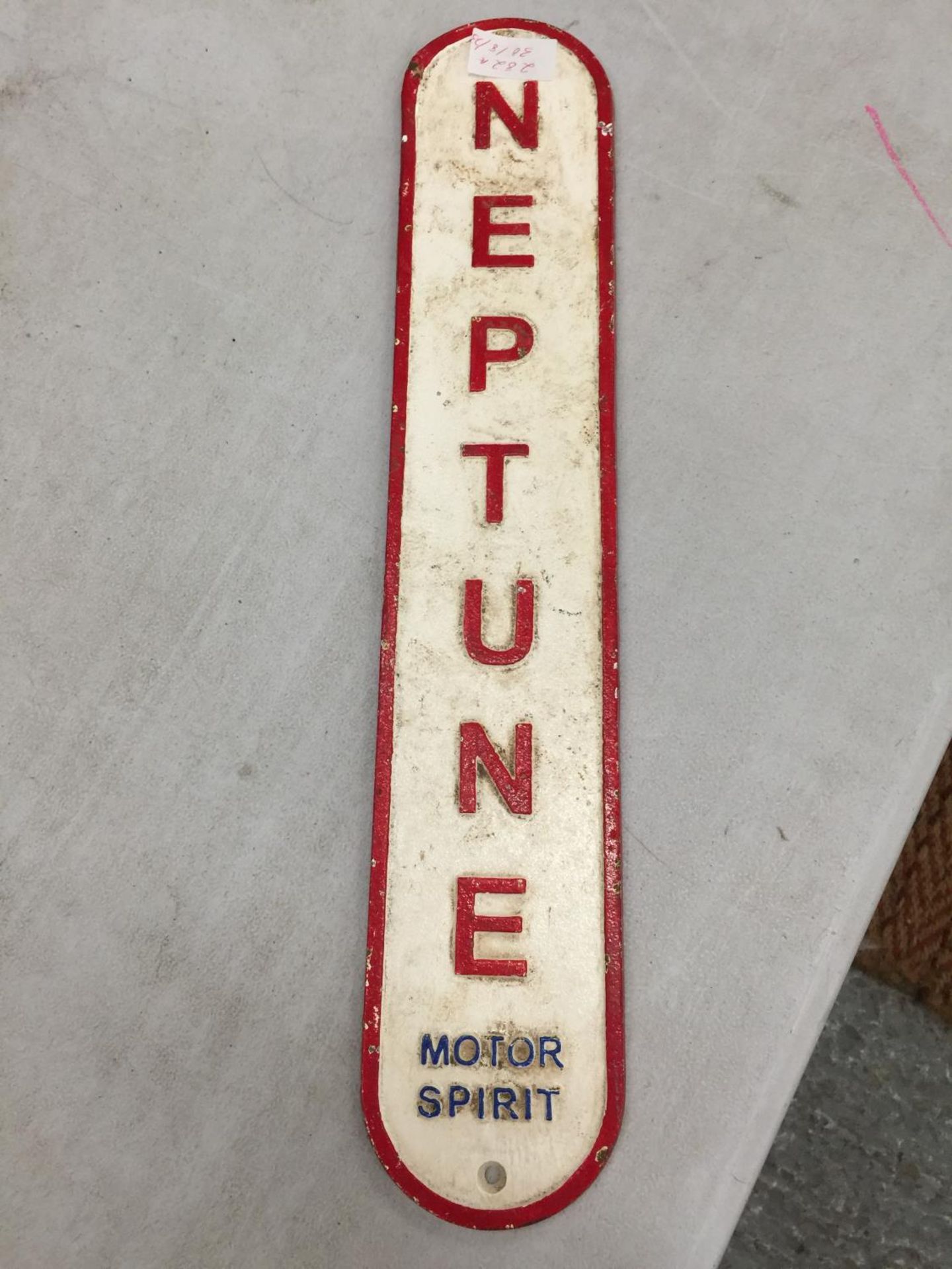 A CAST IRON NEPTUNE MOTOR SPORT SIGN