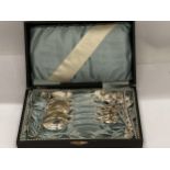 A CASED SET OF 800 GRADE CONTINENTAL SILVER TEASPOONS WITH MATCHING TONGS AND STICKS WITH FLORAL