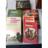 A COLLECTION OF CHESS BOOKS AND BOXED CHESS PIECES