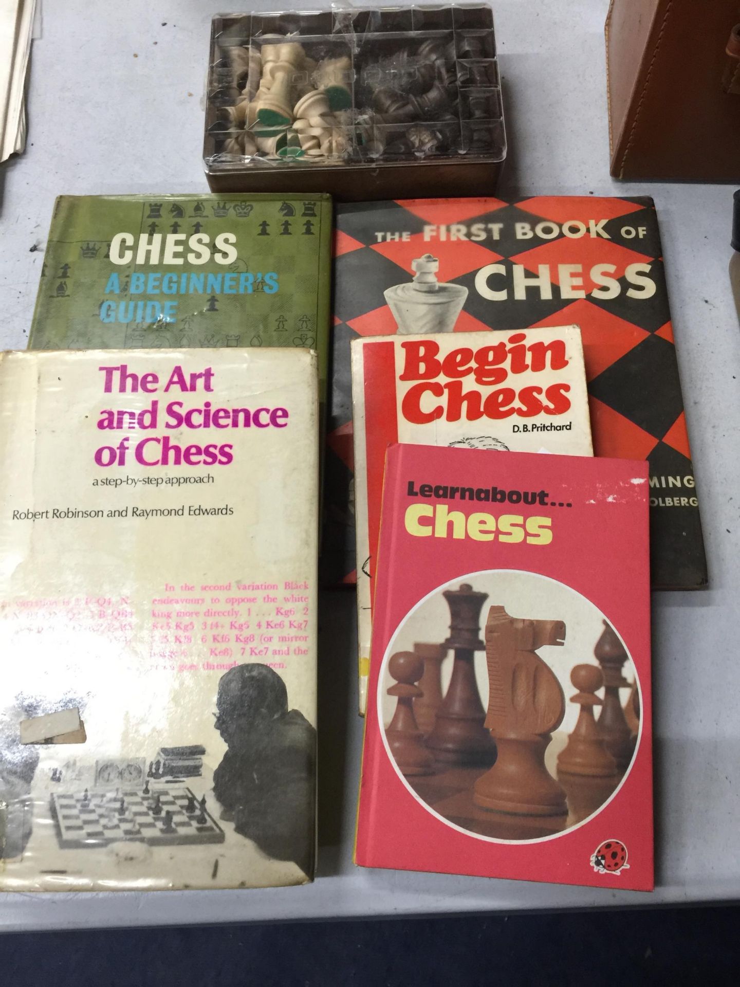 A COLLECTION OF CHESS BOOKS AND BOXED CHESS PIECES