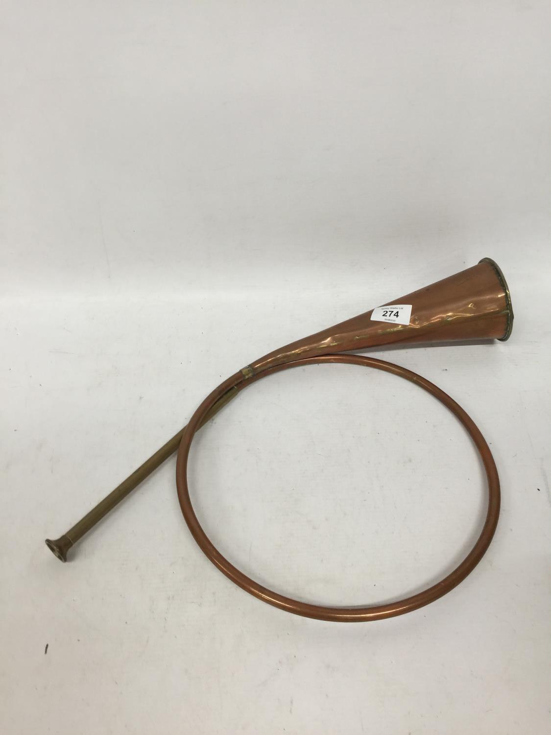 A VINTAGE COILED COPPER HUNTING HORN
