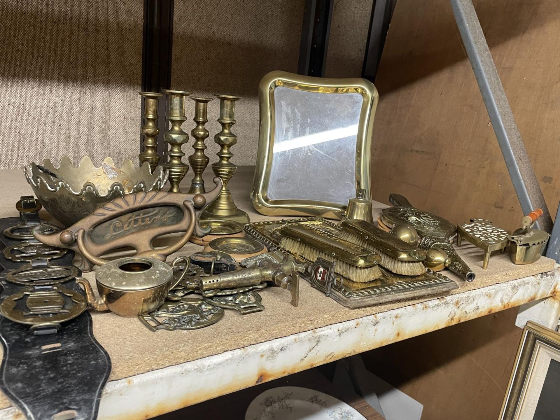 A VERY LARGE QUANTITY OF BRASS TO INCLUDE CANDLESTICKS, A PICTURE FRAME, PAN STAND, KEY RACK, ETC.,