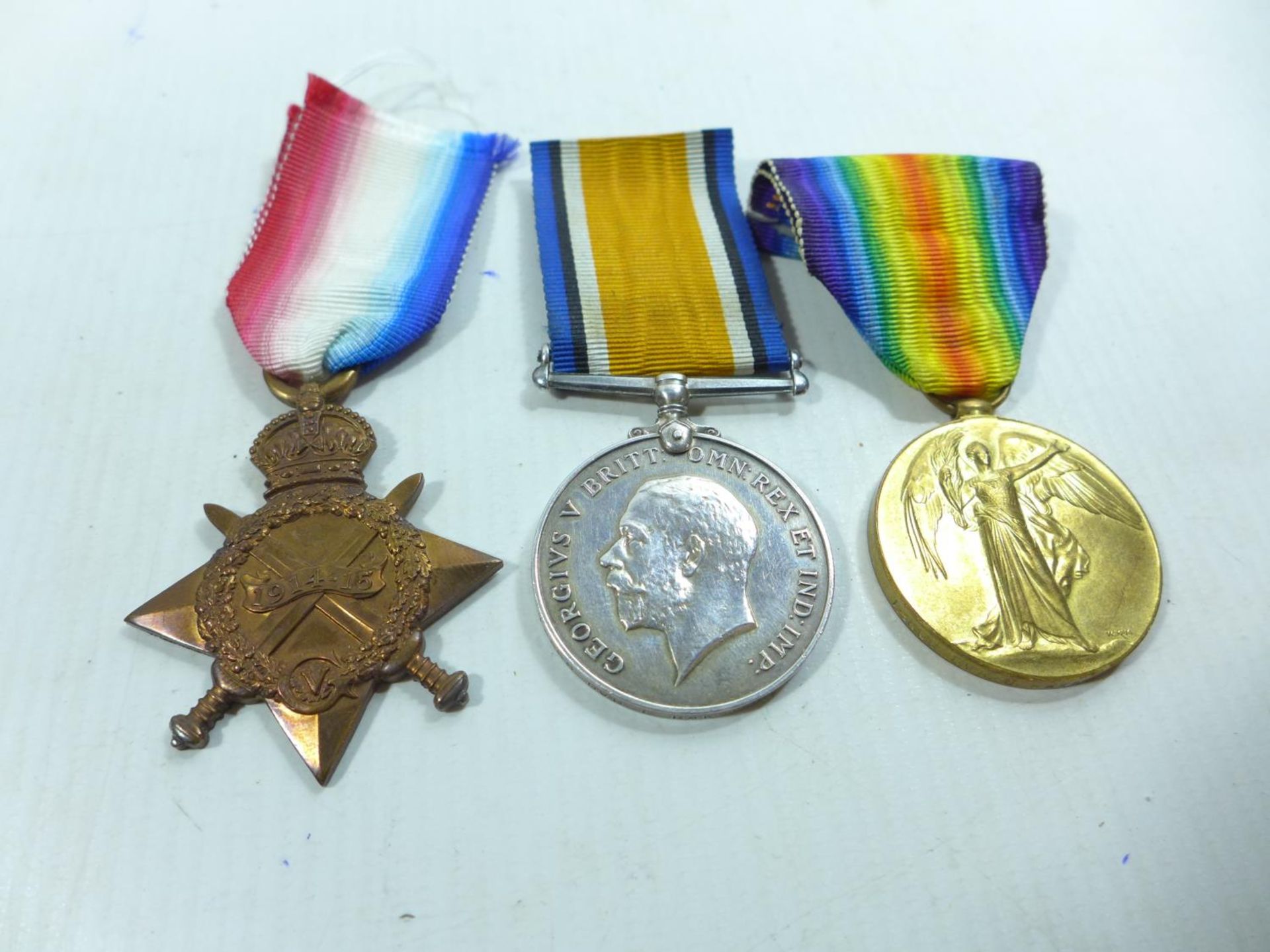 A WORLD WAR I TRIO MEDAL GROUP AWARDED TO 5-866 DRIVER E RAWSON OF THE ARMY SERVICE CORPS