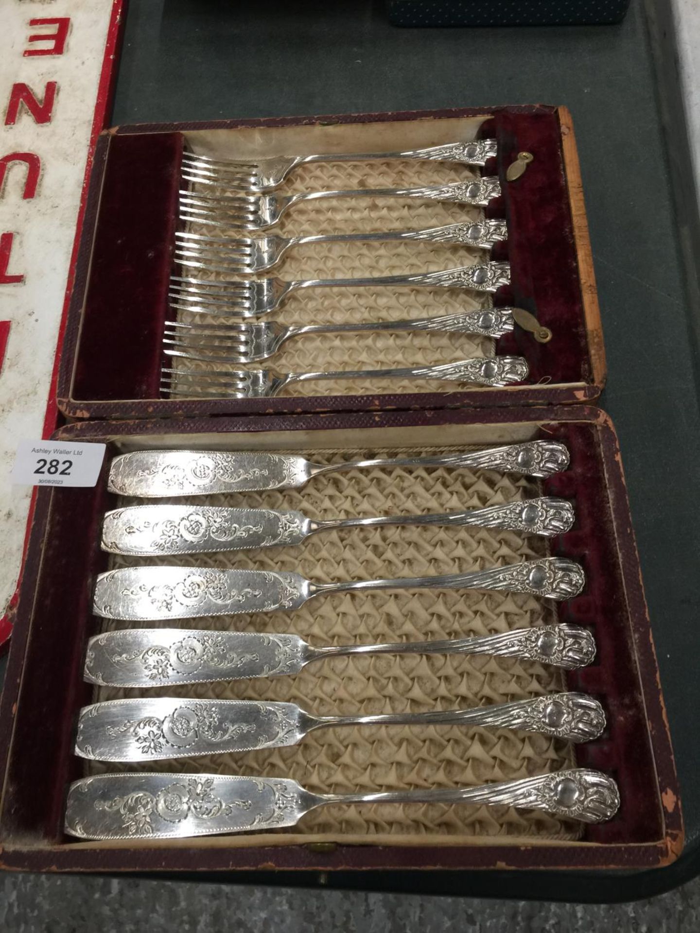 A VINTAGE BOX OF FISH KNIVES AND FORKS