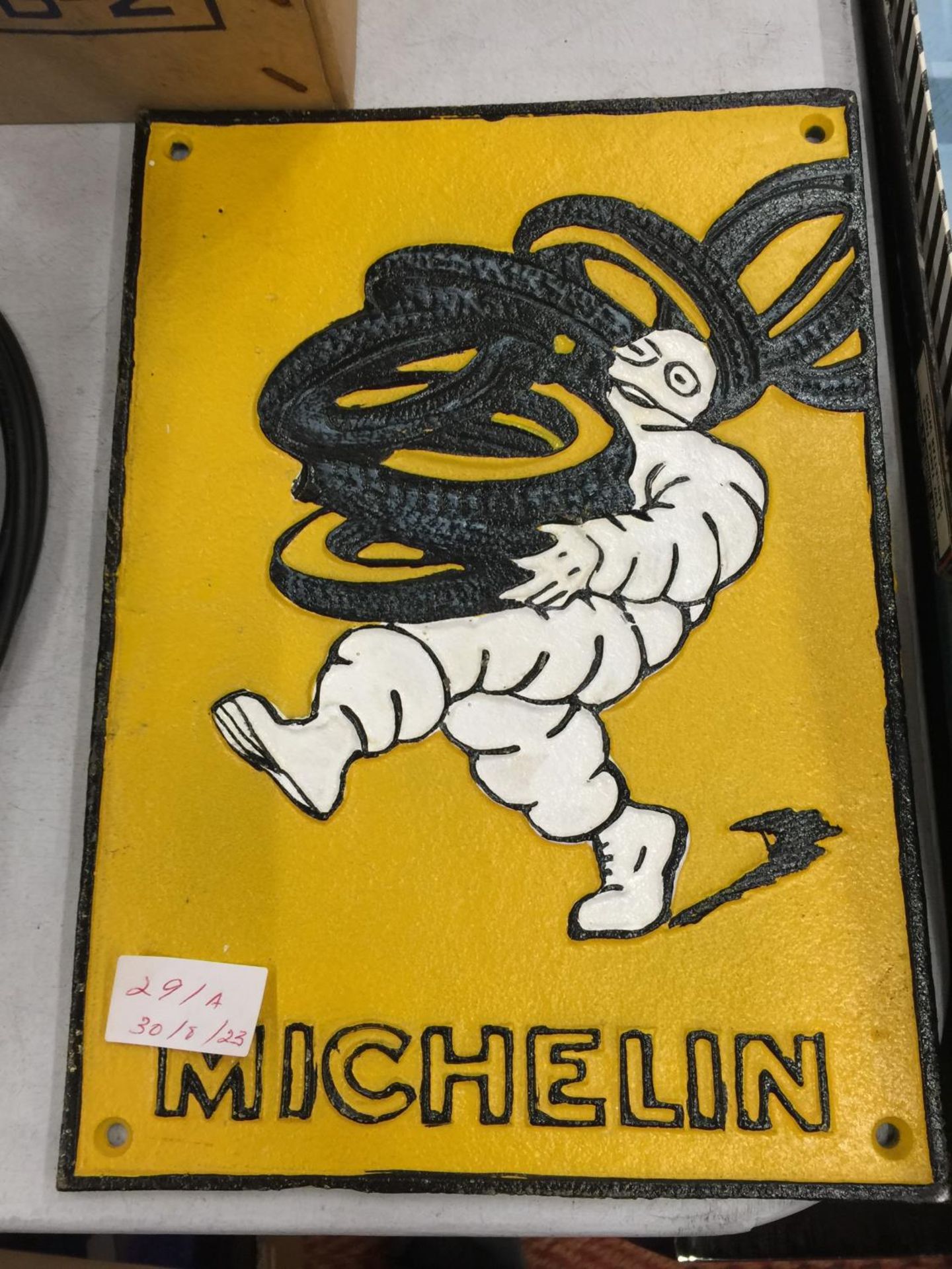 A CAST IRON MICHELIN MAN SIGN